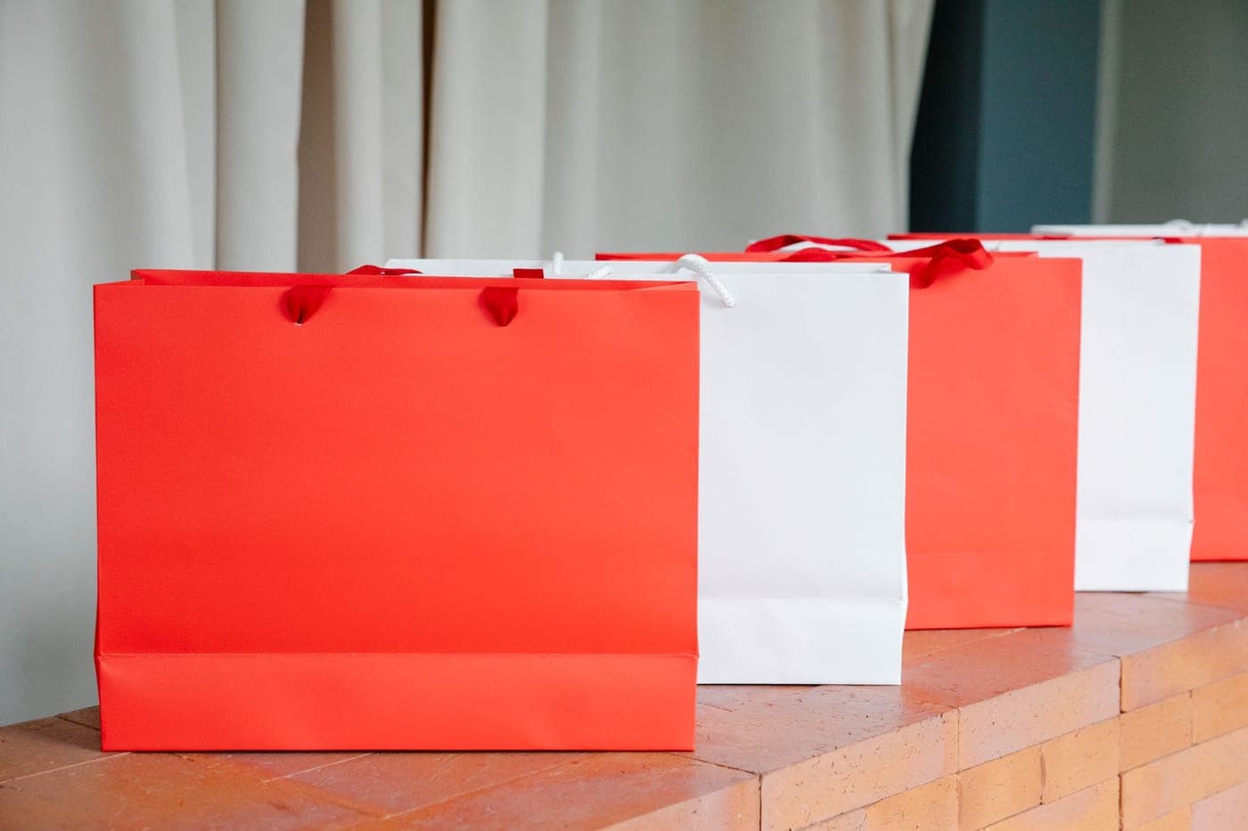 A gift shop counter with a wrapped parcel and a paper bag