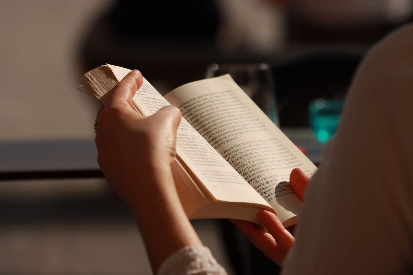 A pair of hands holding an open book